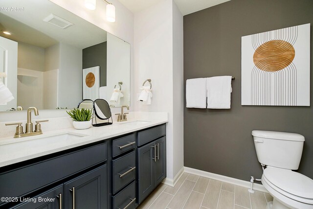 2309 Serenity Rdg Way, Louisville, KY 40023 - full bathroom with baseboards, a sink, double vanity, and toilet