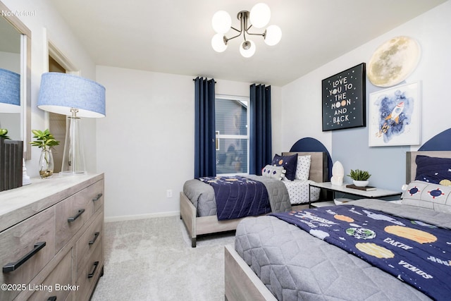 bedroom featuring light colored carpet, baseboards, and a chandelier