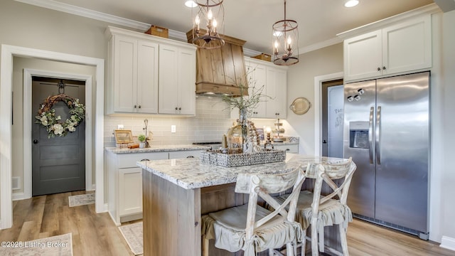 157 Tommy Ct, Shepherdsville, KY 40165 - kitchen featuring crown molding, light stone countertops, stainless steel fridge, light wood-type flooring, and backsplash