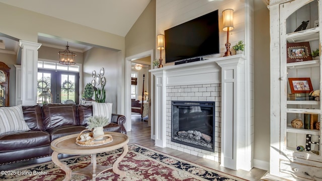 157 Tommy Ct, Shepherdsville, KY 40165 - living area with french doors, a brick fireplace, wood finished floors, lofted ceiling, and ornamental molding