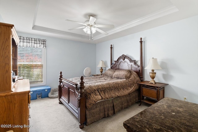 bedroom featuring ornamental molding, a raised ceiling, ceiling fan, and light carpet