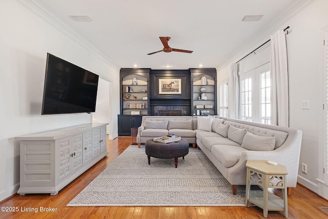 1203 Winding Creek Pl, Louisville, KY 40245 - living room with a ceiling fan, ornamental molding, built in shelves, and light wood finished floors