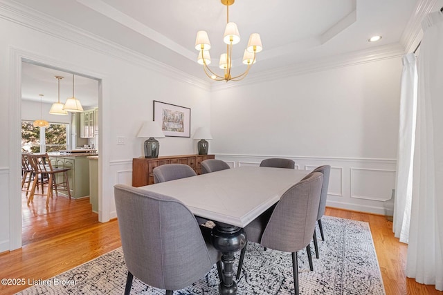 1203 Winding Creek Pl, Louisville, KY 40245 - dining space with crown molding, wainscoting, a raised ceiling, a chandelier, and light wood-type flooring
