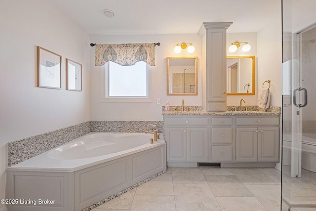 1203 Winding Creek Pl, Louisville, KY 40245 - full bathroom with double vanity, a garden tub, visible vents, a sink, and toilet