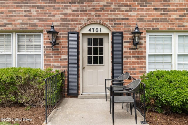 entrance to property with brick siding