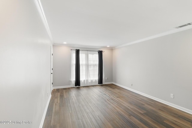 unfurnished room with baseboards, ornamental molding, visible vents, and dark wood-style floors