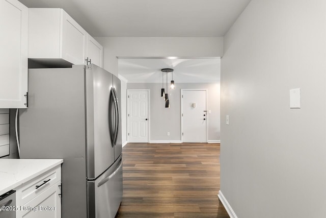 kitchen featuring freestanding refrigerator, baseboards, dark wood-style flooring, and white cabinets