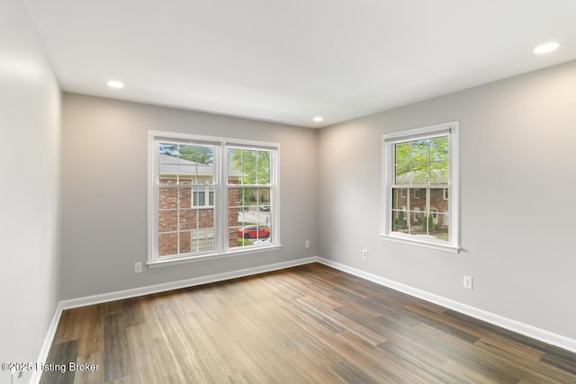 unfurnished room featuring recessed lighting, baseboards, and wood finished floors