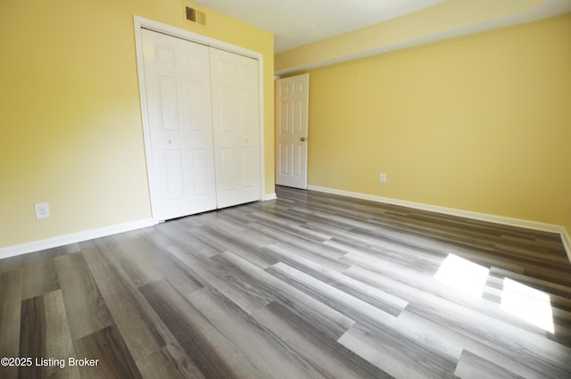 404 La Fontenay Ct, Louisville, KY 40223 - unfurnished bedroom with baseboards, a closet, wood finished floors, and visible vents