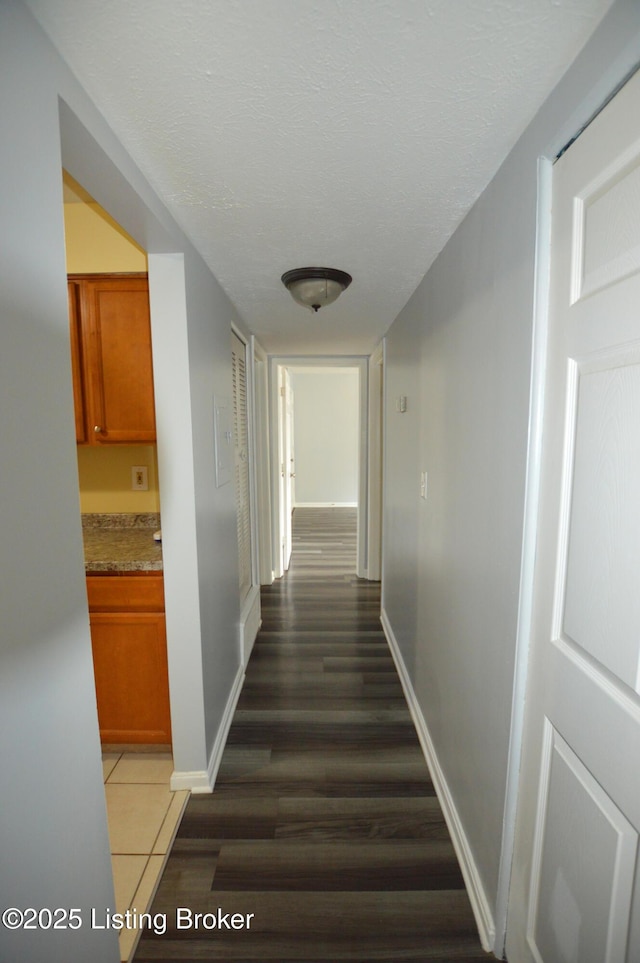 404 La Fontenay Ct, Louisville, KY 40223 - hall featuring a textured ceiling, baseboards, and dark wood-type flooring