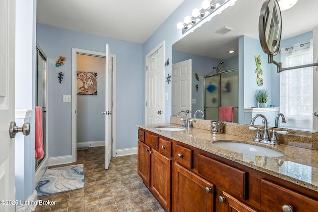 full bathroom featuring visible vents, a sink, double vanity, and a shower stall