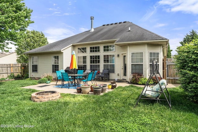 back of property featuring fence, a patio, a yard, and an outdoor fire pit