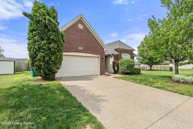traditional-style home featuring a garage, fence, a front yard, brick siding, and driveway