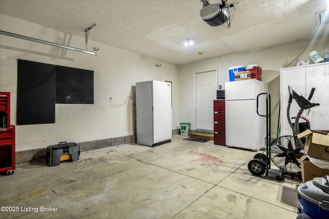 garage with freestanding refrigerator and a garage door opener