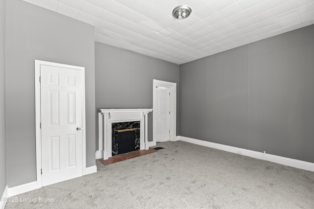 unfurnished living room with carpet floors, visible vents, and a fireplace