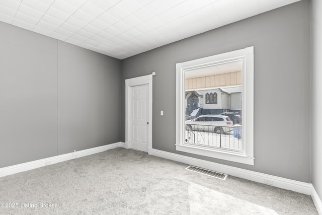 spare room with carpet floors and visible vents