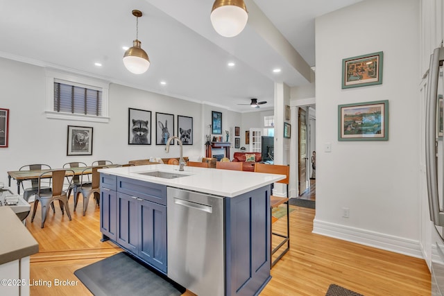 kitchen featuring stainless steel dishwasher, a sink, recessed lighting, ornamental molding, and light wood-type flooring