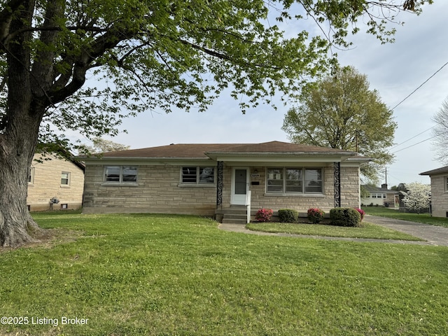 view of front of home with stone siding and a front lawn