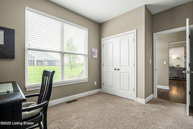 office area featuring visible vents, baseboards, and carpet floors