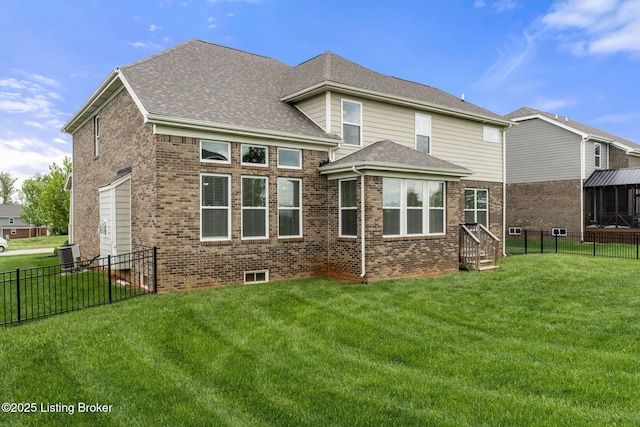 rear view of property featuring central air condition unit, a yard, brick siding, and a fenced backyard