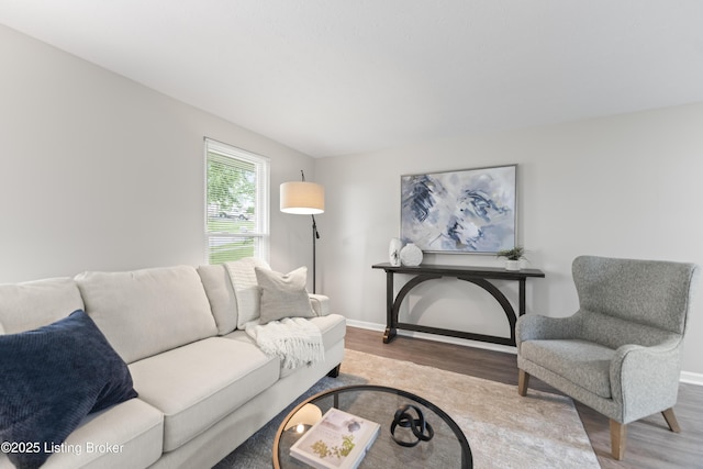 living room featuring baseboards and wood finished floors