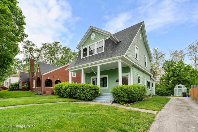 717 Highland Ave, Carrollton, KY 41008 - view of front of property featuring an outdoor structure, a front yard, a shed, and roof with shingles