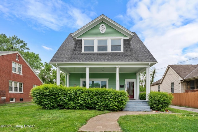 717 Highland Ave, Carrollton, KY 41008 - view of front of house with a porch, fence, roof with shingles, and a front lawn
