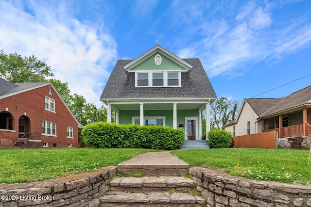 717 Highland Ave, Carrollton, KY 41008 - bungalow-style house with roof with shingles, covered porch, and a front yard