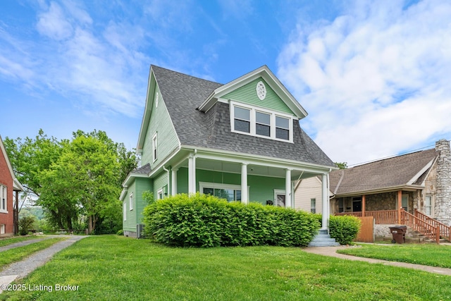 717 Highland Ave, Carrollton, KY 41008 - view of front facade featuring covered porch, a shingled roof, and a front lawn