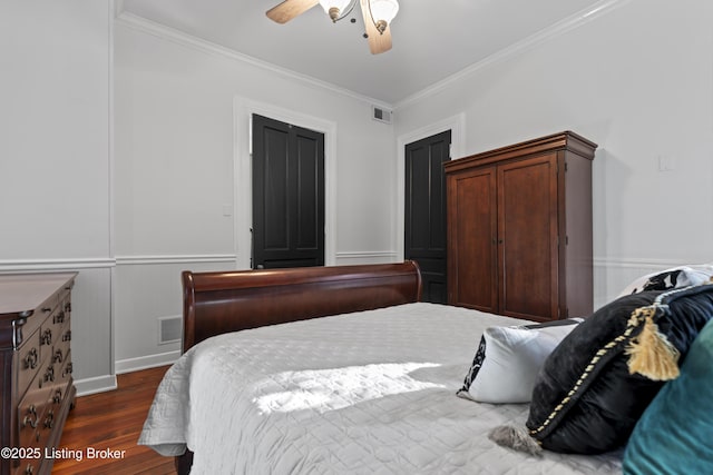 1332 S 2nd St, Louisville, KY 40208 - bedroom with crown molding, wainscoting, dark wood finished floors, a ceiling fan, and visible vents