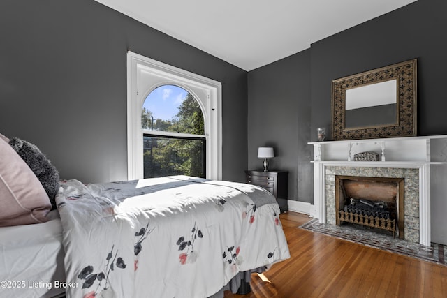 1332 S 2nd St, Louisville, KY 40208 - bedroom featuring baseboards, wood finished floors, and a tile fireplace
