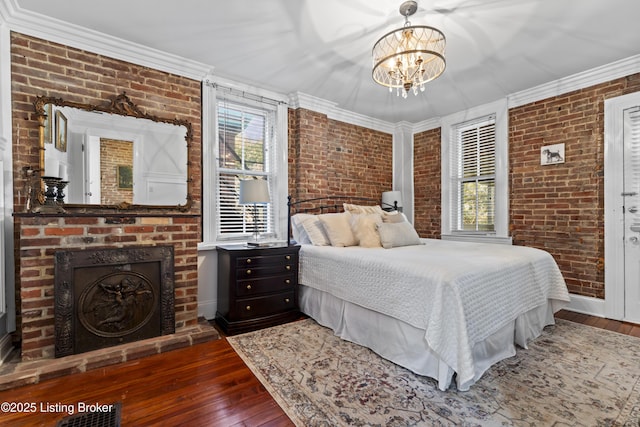 1332 S 2nd St, Louisville, KY 40208 - bedroom featuring brick wall, multiple windows, and hardwood / wood-style floors