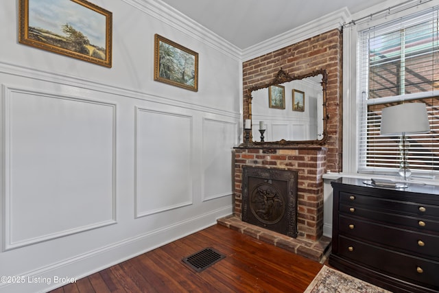 1332 S 2nd St, Louisville, KY 40208 - interior space with a fireplace, a decorative wall, visible vents, ornamental molding, and hardwood / wood-style flooring