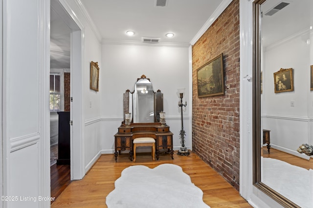 1332 S 2nd St, Louisville, KY 40208 - corridor with light wood finished floors, brick wall, and visible vents