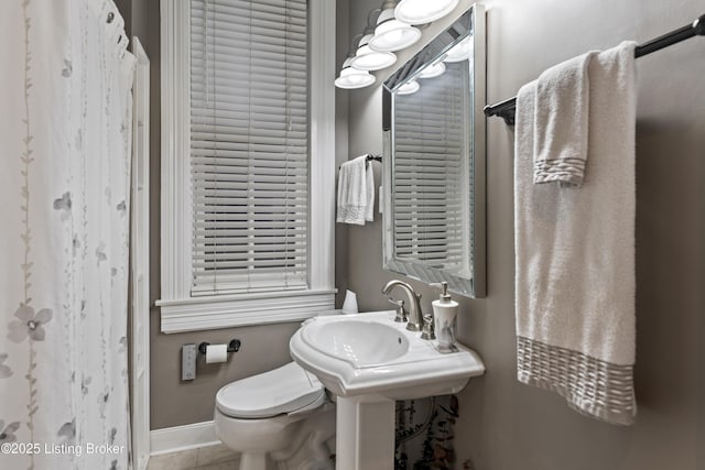 1332 S 2nd St, Louisville, KY 40208 - bathroom featuring baseboards, tile patterned floors, and toilet