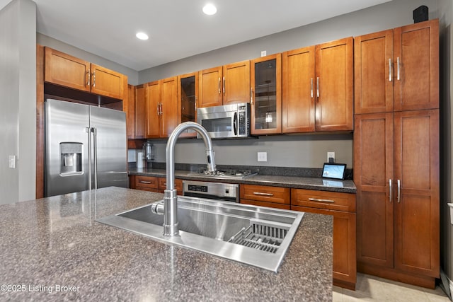 1332 S 2nd St, Louisville, KY 40208 - kitchen with brown cabinetry, recessed lighting, dark countertops, and stainless steel appliances