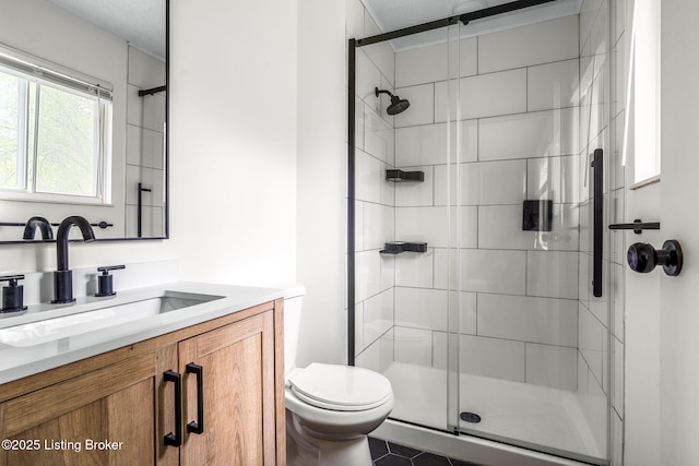 full bathroom featuring a stall shower, toilet, and vanity