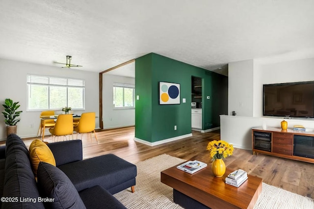 living room with wood finished floors and baseboards