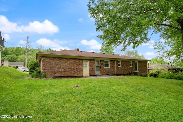7411 Colt Dr, Louisville, KY 40214 - rear view of property featuring brick siding, a yard, and a chimney