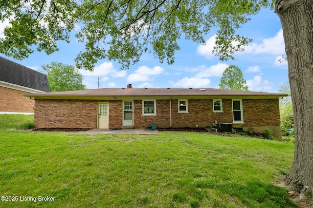 7411 Colt Dr, Louisville, KY 40214 - back of property with brick siding, central air condition unit, a yard, and a patio