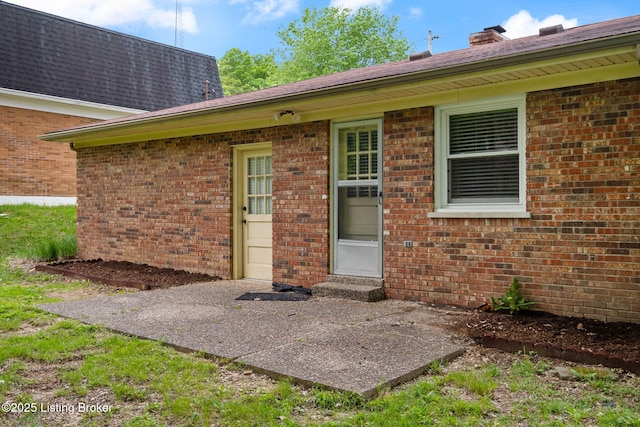 7411 Colt Dr, Louisville, KY 40214 - doorway to property featuring brick siding and roof with shingles