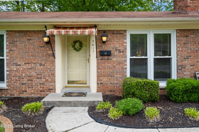 7411 Colt Dr, Louisville, KY 40214 - doorway to property featuring brick siding, a chimney, and roof with shingles