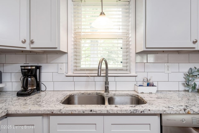 7411 Colt Dr, Louisville, KY 40214 - kitchen featuring stainless steel dishwasher, white cabinets, tasteful backsplash, light stone counters, and a sink
