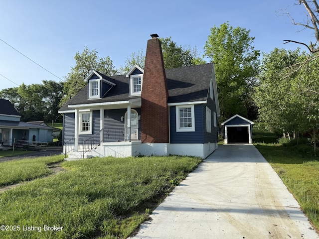cape cod-style house featuring a detached garage, a porch, an outbuilding, a chimney, and concrete driveway