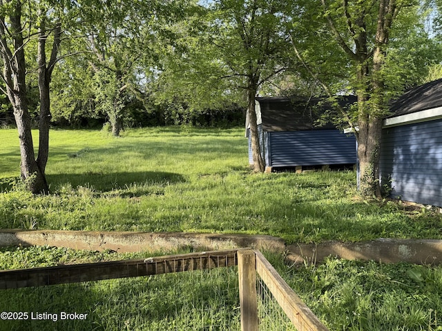 view of yard featuring a storage shed and an outbuilding