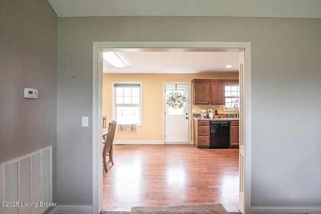 450 Rolling Way, Smiths Grove, KY 42171 - hall featuring baseboards, a sink, visible vents, and light wood-style flooring