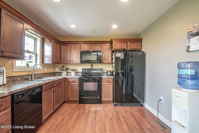 450 Rolling Way, Smiths Grove, KY 42171 - kitchen featuring recessed lighting, light wood finished floors, a sink, and black appliances