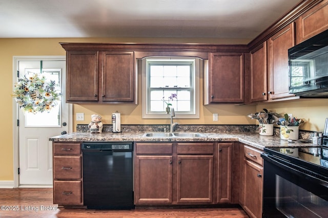 450 Rolling Way, Smiths Grove, KY 42171 - kitchen featuring dark stone countertops, a sink, black appliances, and wood finished floors