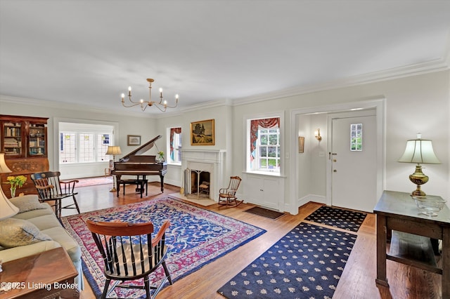 2335 Bonnycastle Ave, Louisville, KY 40205 - living area with crown molding, a chandelier, wood finished floors, and a fireplace