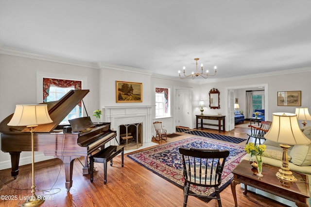 2335 Bonnycastle Ave, Louisville, KY 40205 - living room with wood finished floors, crown molding, a chandelier, a fireplace with flush hearth, and baseboards